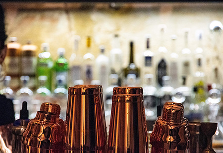 Bar with liquor bottles and cocktail shakers