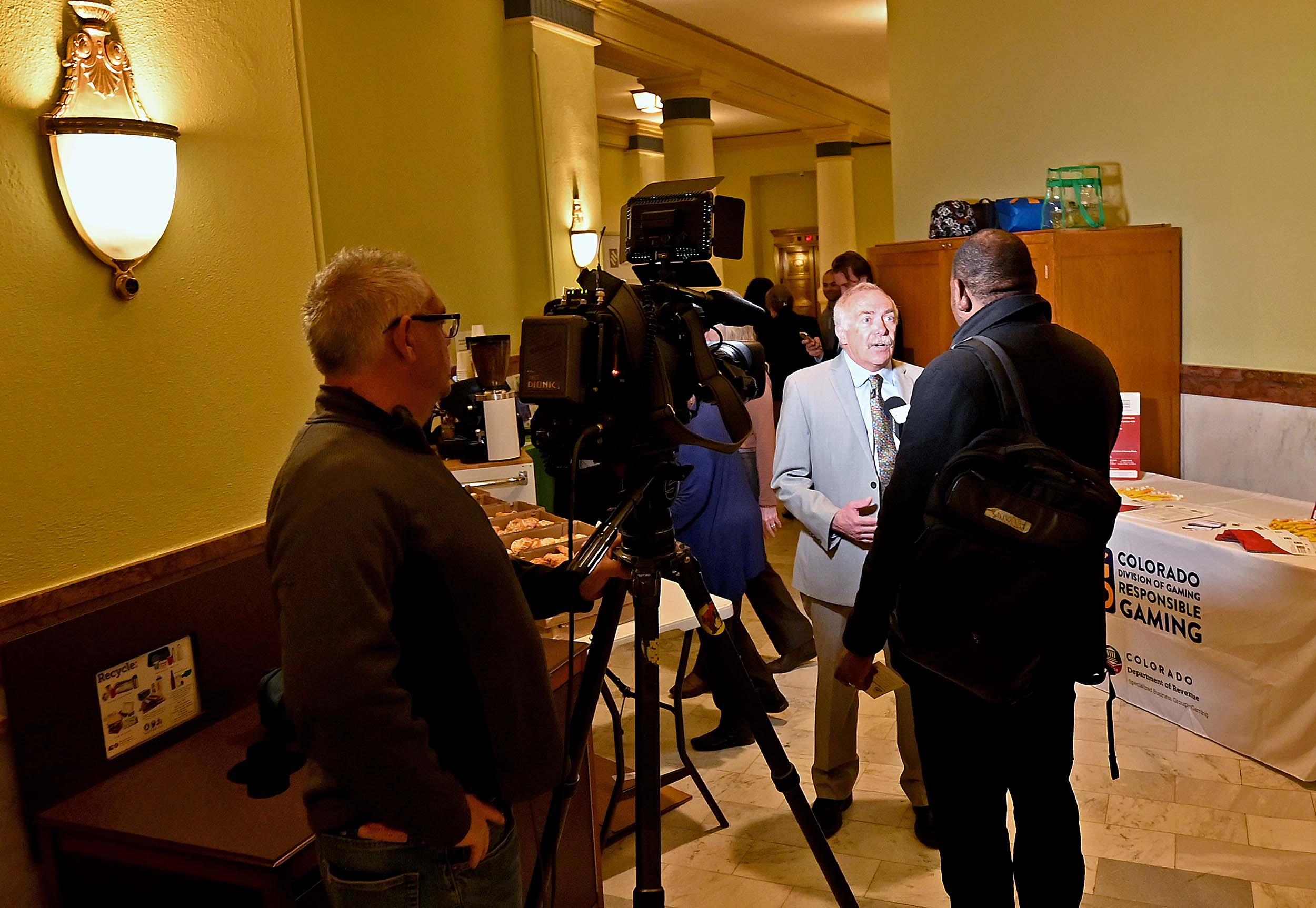 Colorado Lottery Director Tom Seaver (middle) speaks about problem gambling awareness with a reporter on Wednesday, Feb. 26, 2025 at the state capitol in Denver.The Colorado Division of Gaming and the Colorado Lottery, both divisions of the Colorado Department of Revenue, raised problem gambling awareness inside the state capitol in Denver as part of Problem Gambling Awareness Day. Staff members shared problem gambling resources with lawmakers and statehouse visitors in an effort to highlight Problem Gambling Awareness Month. (Derek Kuhn/CDOR Photo)