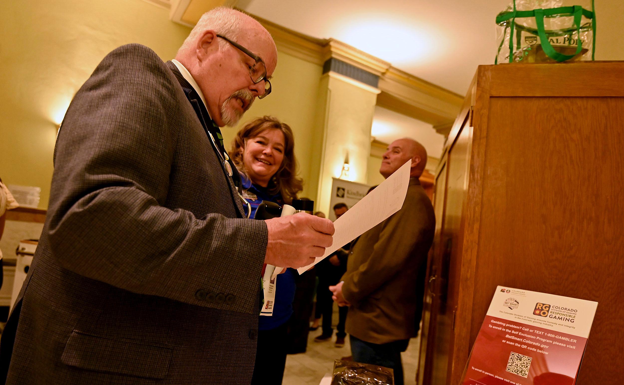 Colorado Division of Gaming Responsible Gaming Manager Corrie Martinez (middle) speaks with state Sen. Tom Sullivan about problem gambling awareness on Wednesday, Feb. 26, 2025 at the state capitol in Denver. The Colorado Division of Gaming and the Colorado Lottery, both divisions of the Colorado Department of Revenue, raised problem gambling awareness inside the state capitol in Denver as part of Problem Gambling Awareness Day.